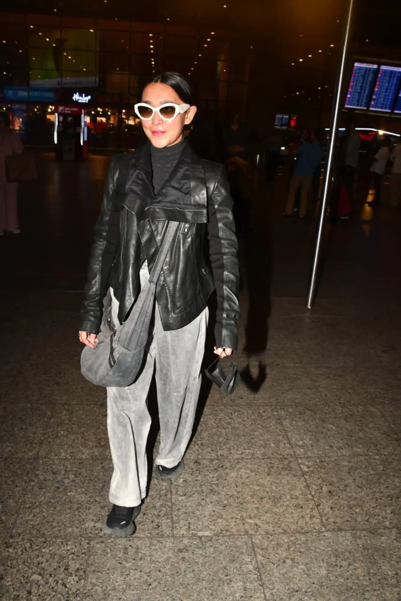 Sayani Gupta turned heads at the airport in a sleek black top paired with a edgy latex jacket and loose grey pants.However, her sunglasses stole the show.